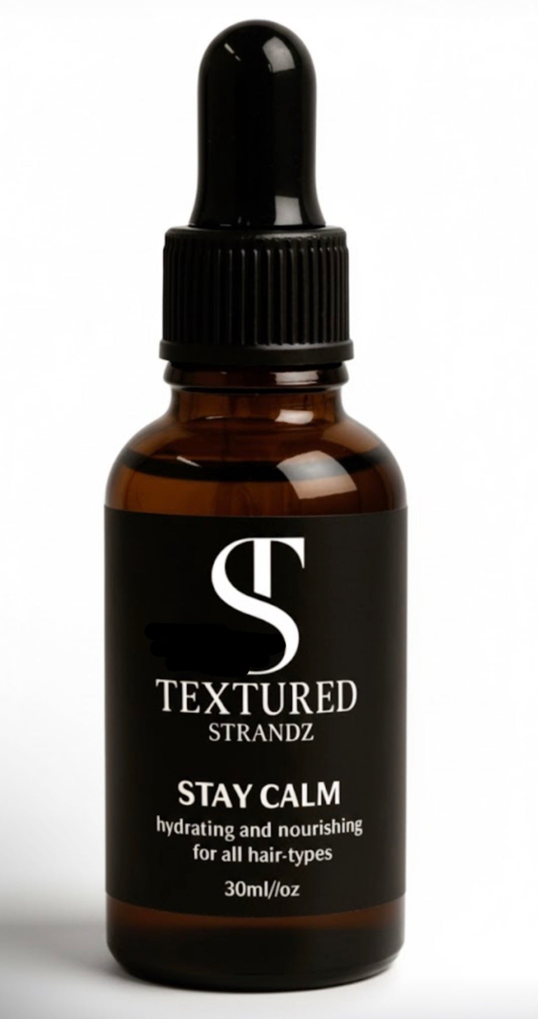 Brown glass bottle with black cap labeled 'Textured Strandz' on a white background