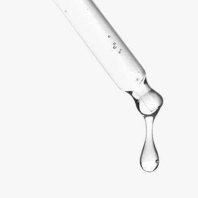 Close-up of a dropper with liquid on a white background
