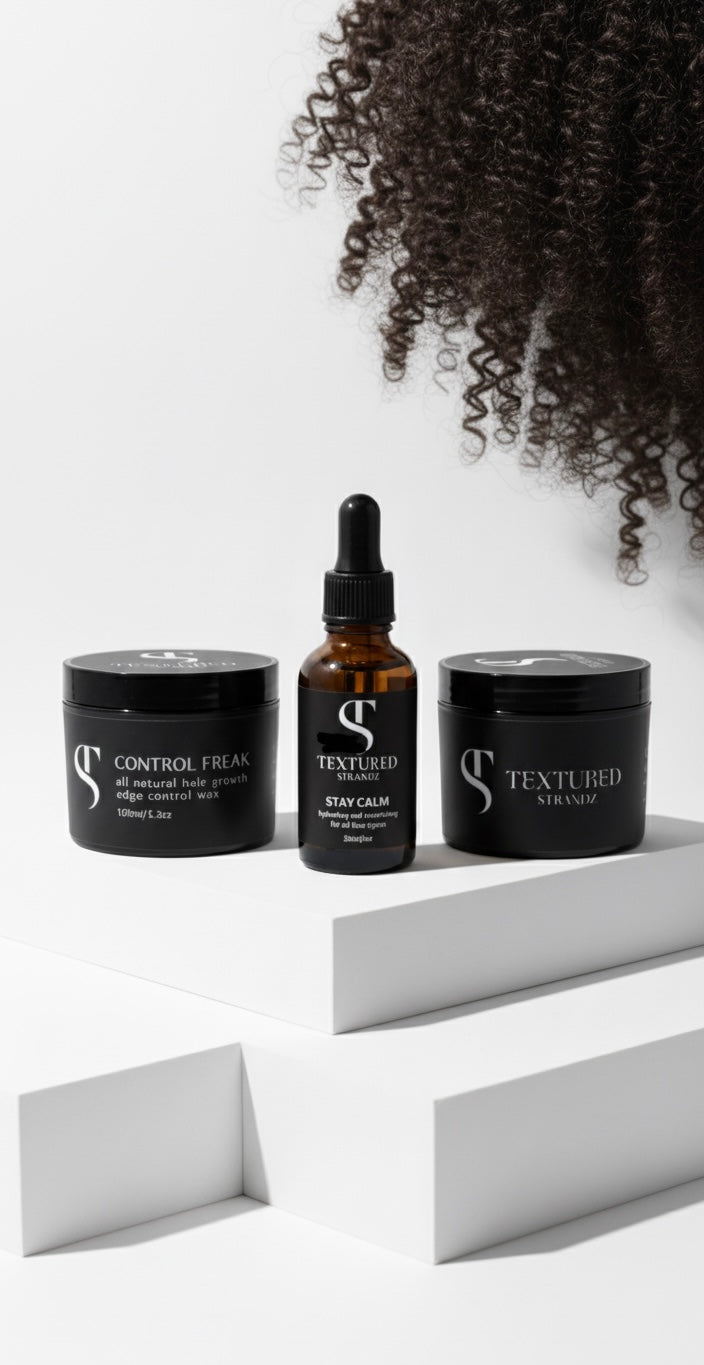 Three hair care products on a white surface with a textured background