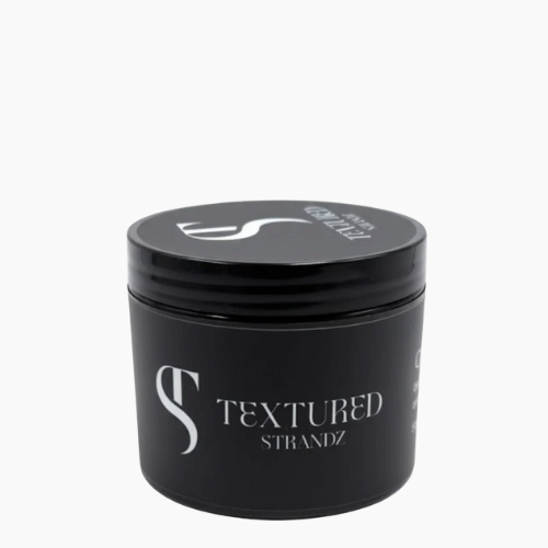 Black jar of 'Textured Strandz' hair product on a white background