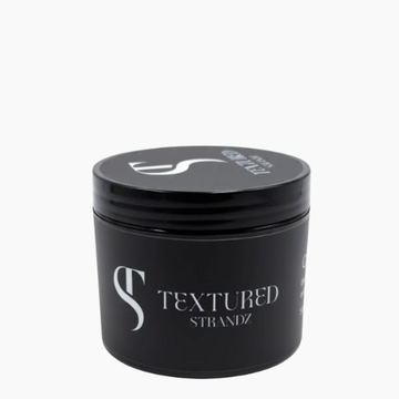 Black jar of 'Textured Strandz' hair product on a white background